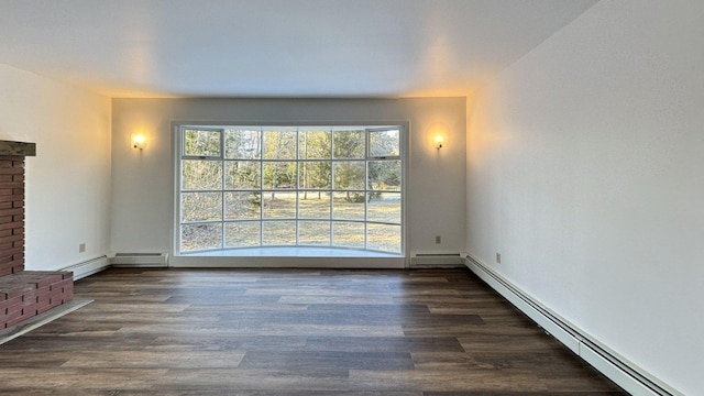 unfurnished living room with a baseboard heating unit and dark wood-style flooring