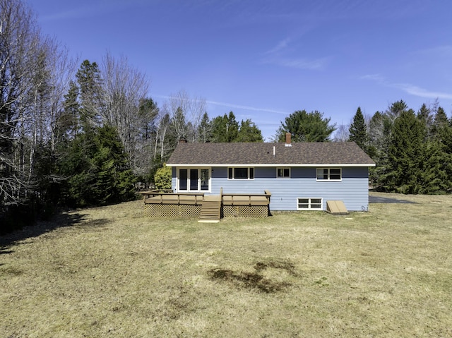 back of house with a chimney, a yard, and a deck