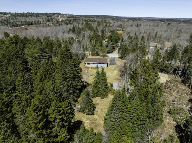 birds eye view of property with a wooded view