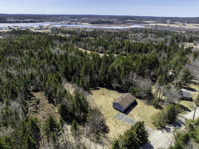 aerial view with a forest view and a water view
