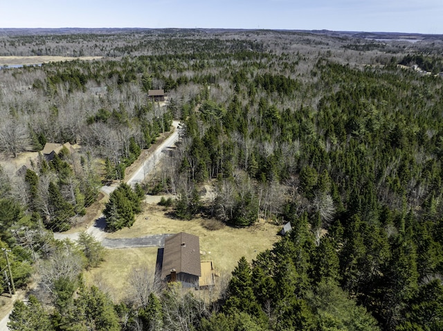 birds eye view of property with a view of trees