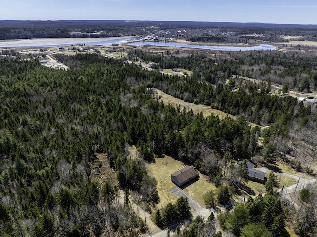 aerial view with a wooded view and a water view