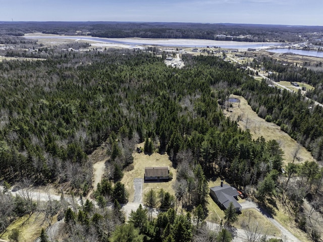 aerial view with a forest view and a water view