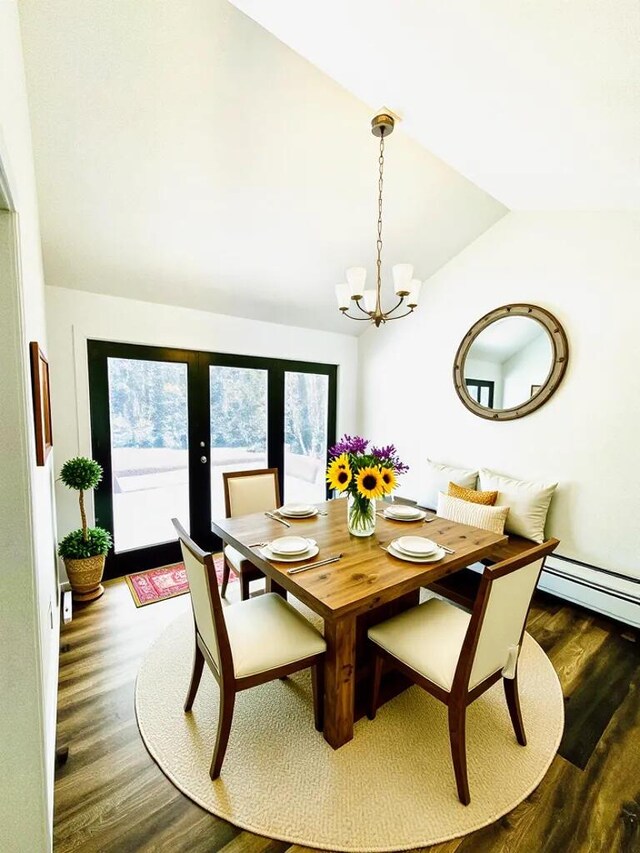 dining area featuring a baseboard heating unit, french doors, an inviting chandelier, lofted ceiling, and wood finished floors