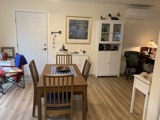 26 Townsend Ln, Boothbay, ME 04537 - dining area with a wall unit AC and light wood finished floors