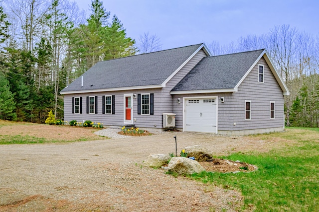 26 Townsend Ln, Boothbay, ME 04537 - view of front of house with an attached garage, dirt driveway, ac unit, and a shingled roof