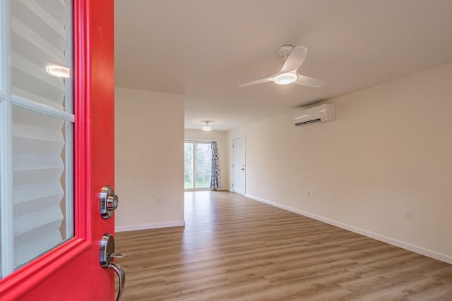 26 Townsend Ln, Boothbay, ME 04537 - unfurnished room featuring baseboards, a ceiling fan, light wood finished floors, and a wall mounted air conditioner