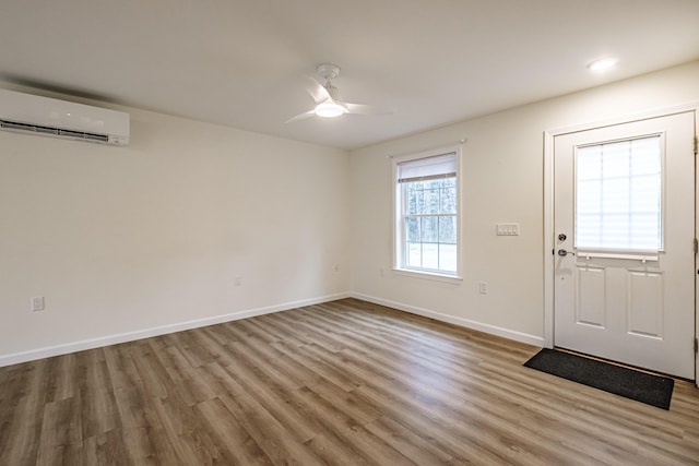 26 Townsend Ln, Boothbay, ME 04537 - foyer with baseboards, ceiling fan, a wall mounted air conditioner, and wood finished floors