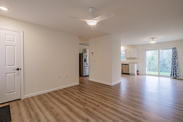26 Townsend Ln, Boothbay, ME 04537 - unfurnished living room featuring baseboards, a ceiling fan, and light wood finished floors