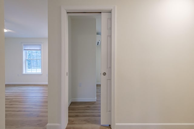 26 Townsend Ln, Boothbay, ME 04537 - corridor with baseboards, a wall mounted AC, and wood finished floors