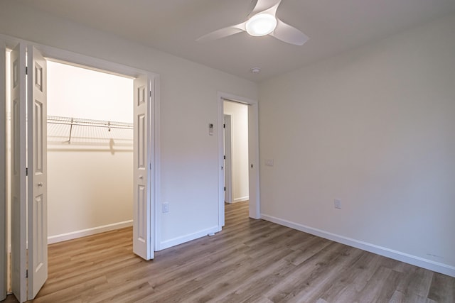 26 Townsend Ln, Boothbay, ME 04537 - unfurnished bedroom featuring light wood-style floors, baseboards, a ceiling fan, and a closet