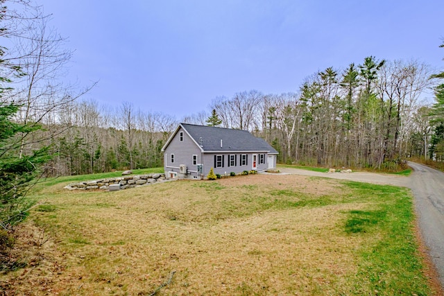 26 Townsend Ln, Boothbay, ME 04537 - exterior space featuring a lawn, a shingled roof, a view of trees, and aphalt driveway