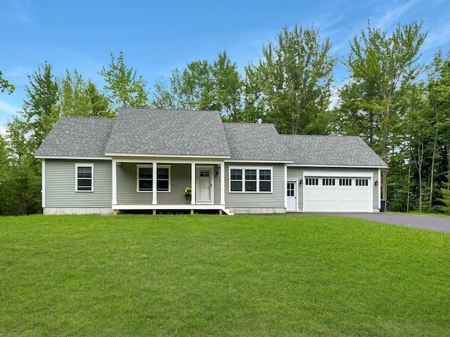 view of front of home featuring a garage, a front lawn, and covered porch