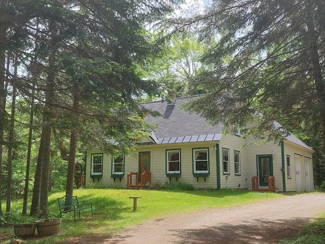 view of front of property featuring a garage and a front lawn