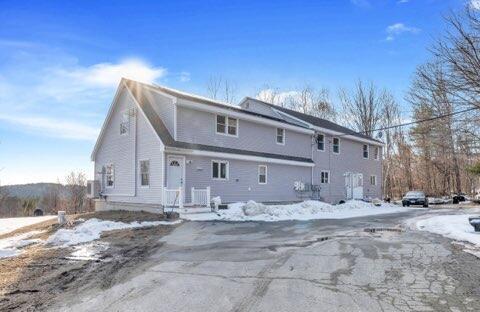 view of snow covered rear of property