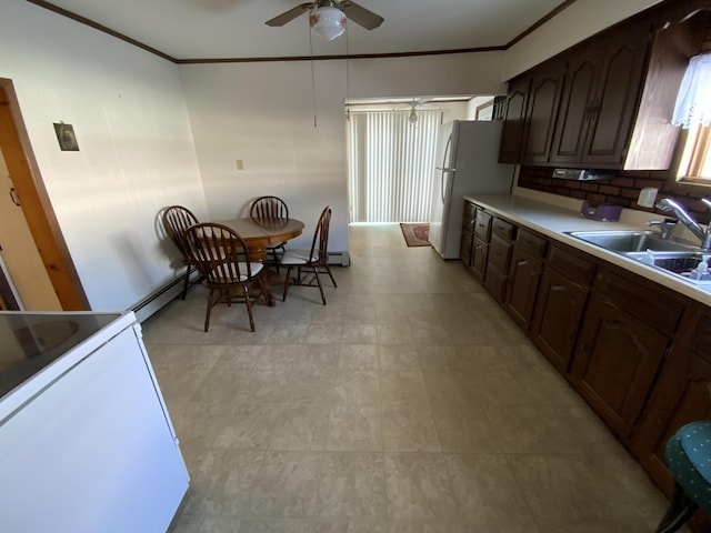 kitchen with sink, white appliances, ornamental molding, and a baseboard heating unit