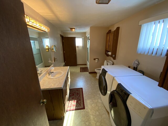 washroom with washer and dryer and sink