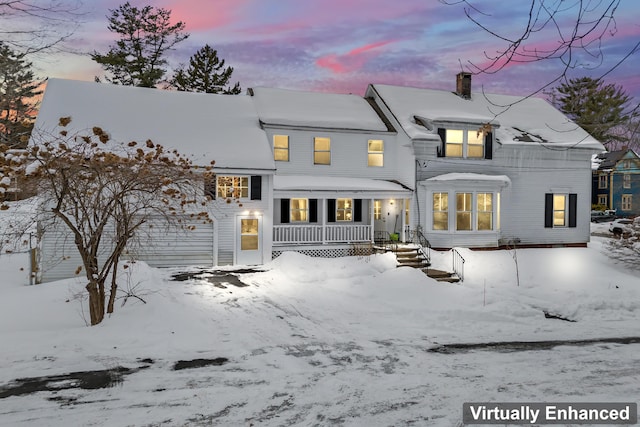 view of snow covered rear of property