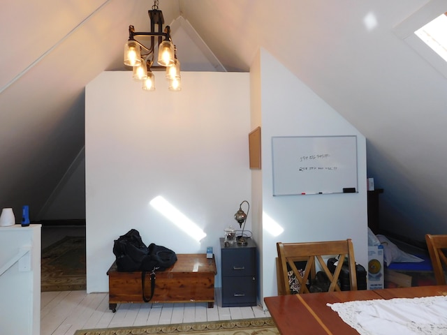 interior space featuring lofted ceiling, light hardwood / wood-style floors, and a chandelier