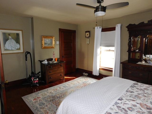 bedroom featuring ceiling fan and dark hardwood / wood-style flooring