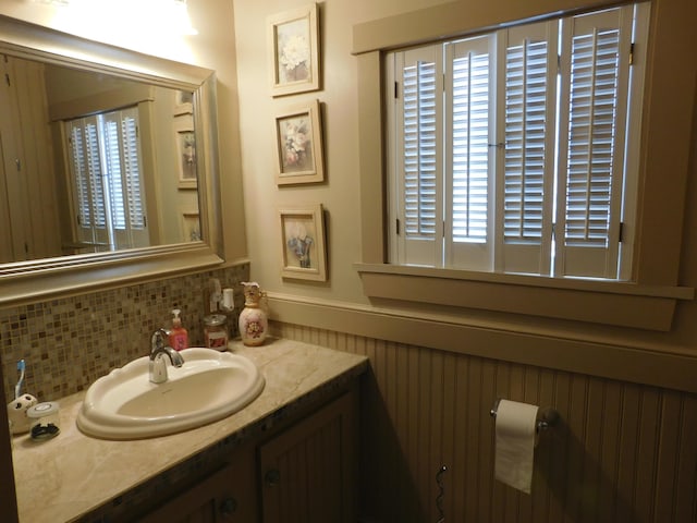 bathroom with vanity and tasteful backsplash