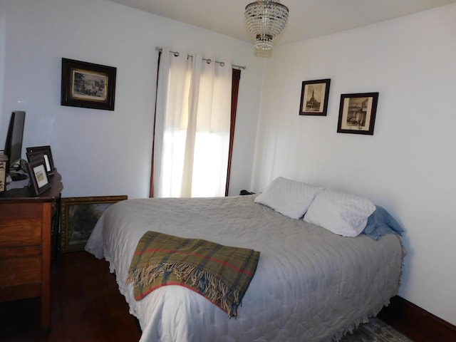 bedroom featuring an inviting chandelier and multiple windows