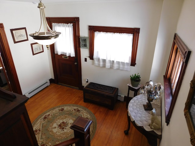 entryway with hardwood / wood-style flooring and a baseboard radiator