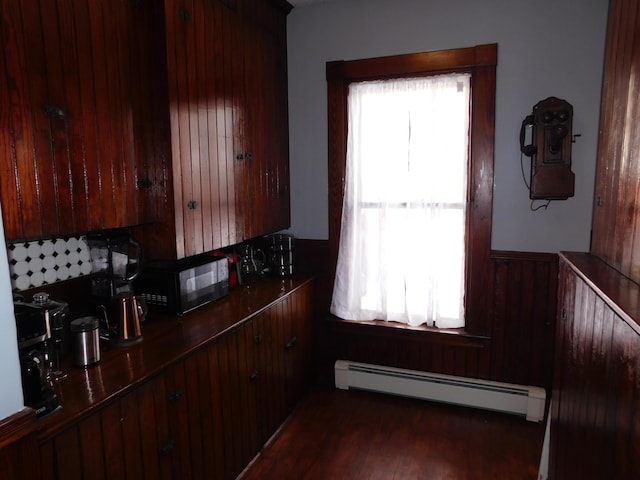 kitchen featuring plenty of natural light, dark wood-type flooring, and baseboard heating