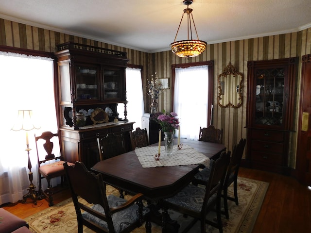 dining area featuring ornamental molding and wood-type flooring