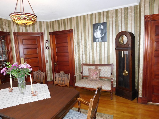 dining space with crown molding and wood-type flooring