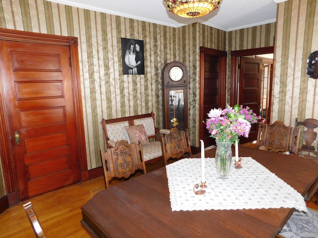 dining room with ornamental molding and light wood-type flooring