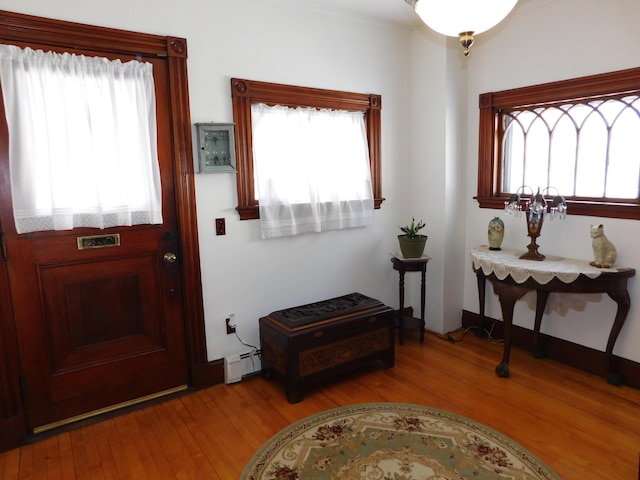 foyer featuring light wood-type flooring and baseboard heating