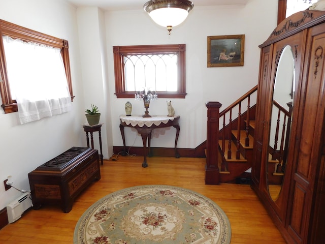 entrance foyer featuring baseboard heating and light wood-type flooring