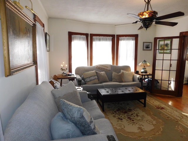 living room with hardwood / wood-style floors and ceiling fan