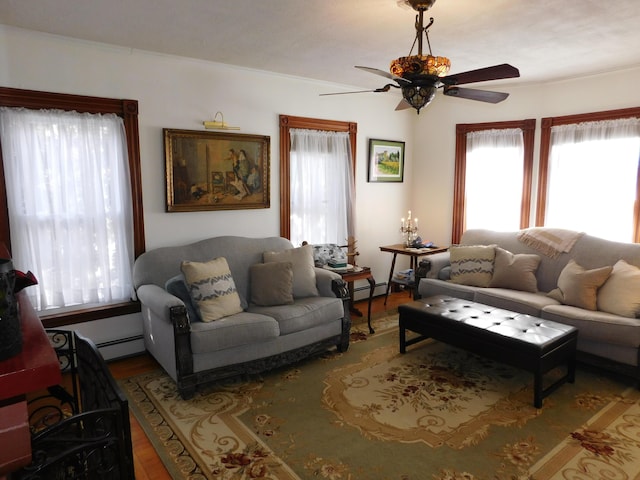 living room with ceiling fan, wood-type flooring, and a baseboard heating unit