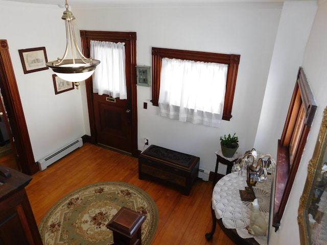 entrance foyer with hardwood / wood-style floors and baseboard heating