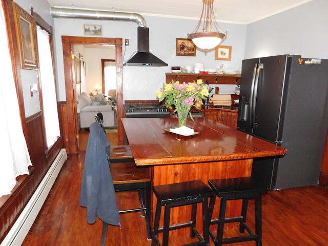 dining area featuring crown molding, a baseboard heating unit, and dark hardwood / wood-style floors