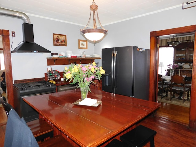 dining space featuring crown molding and dark hardwood / wood-style flooring