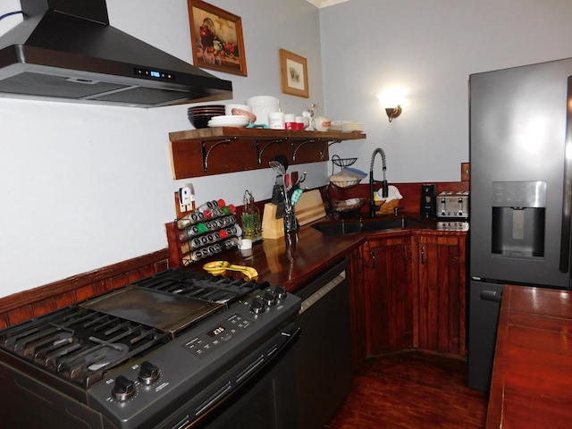 kitchen featuring sink, black dishwasher, stainless steel refrigerator with ice dispenser, range with gas cooktop, and exhaust hood