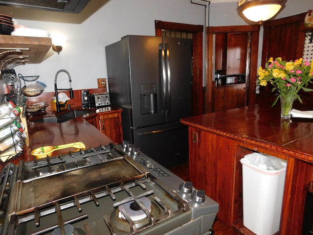 kitchen featuring sink and fridge with ice dispenser