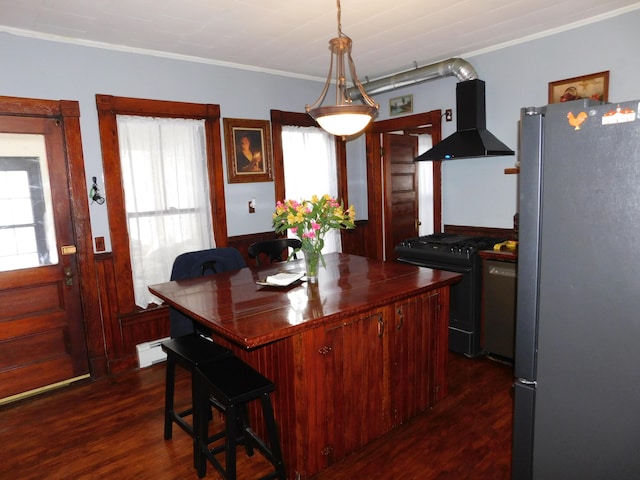 dining space featuring dark wood-type flooring, ornamental molding, and baseboard heating