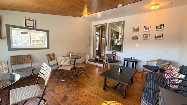 living room with wood-type flooring, vaulted ceiling, and wooden ceiling