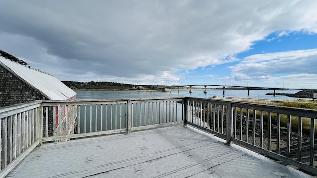 wooden terrace featuring a water view