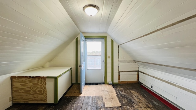 bonus room featuring lofted ceiling, wood ceiling, dark hardwood / wood-style flooring, and wood walls