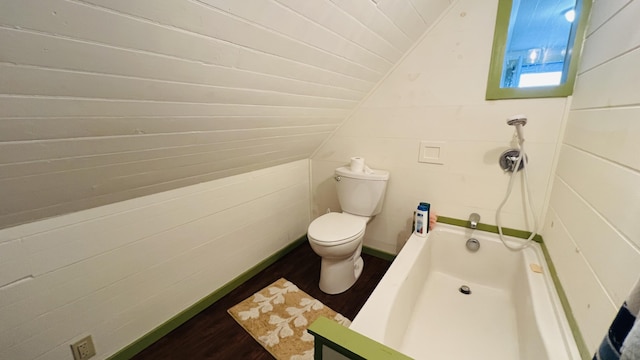 bathroom featuring wood-type flooring, a tub, lofted ceiling, wood ceiling, and toilet