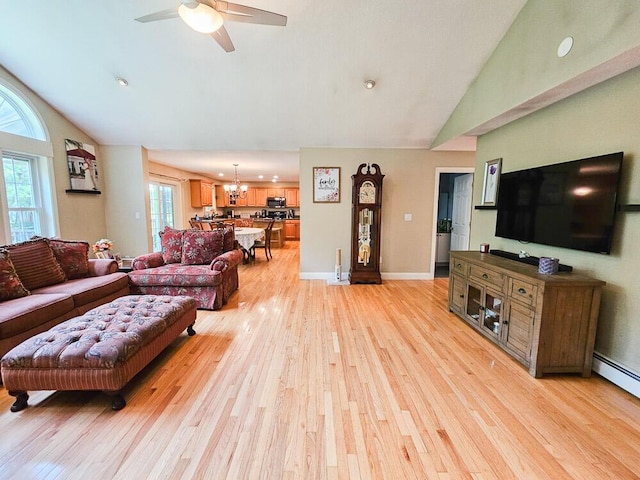 living room with a baseboard radiator, light wood-style flooring, high vaulted ceiling, baseboards, and ceiling fan with notable chandelier