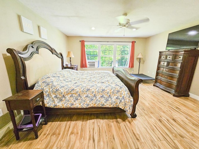 bedroom with light wood finished floors and a ceiling fan