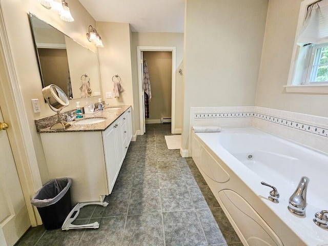 full bathroom featuring a whirlpool tub, double vanity, baseboard heating, and a sink