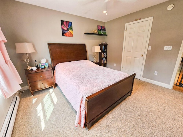 bedroom featuring a baseboard radiator, light carpet, and baseboards