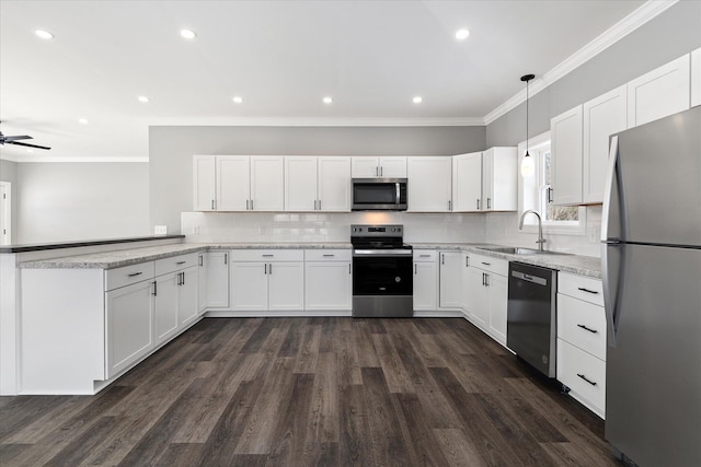 kitchen featuring white cabinetry, sink, pendant lighting, and appliances with stainless steel finishes